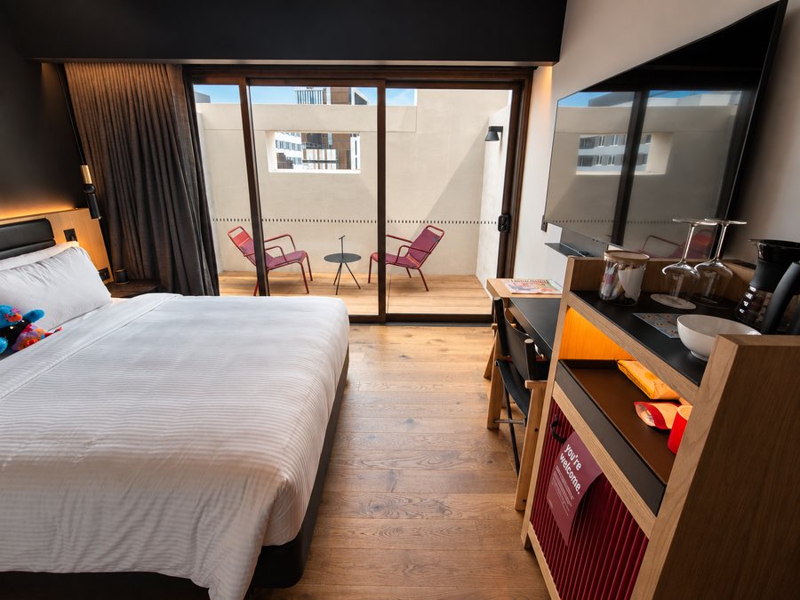 25hours Hotel The Olympia, guest room with a queen bed and a private terrace