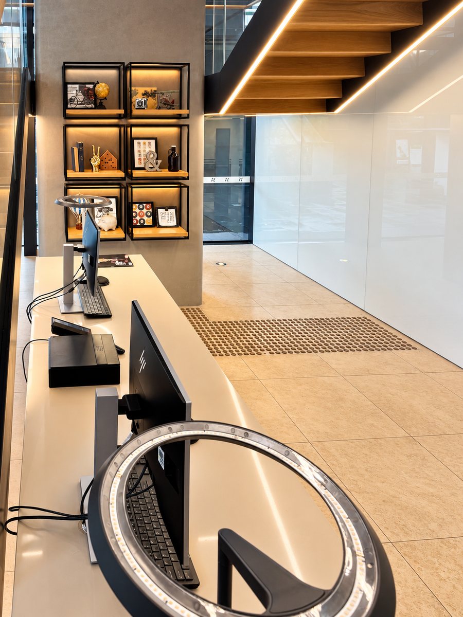 Four Points by Sheraton Sydney, Central Park, lobby workstations beside a lit shelving wall and a timber stair