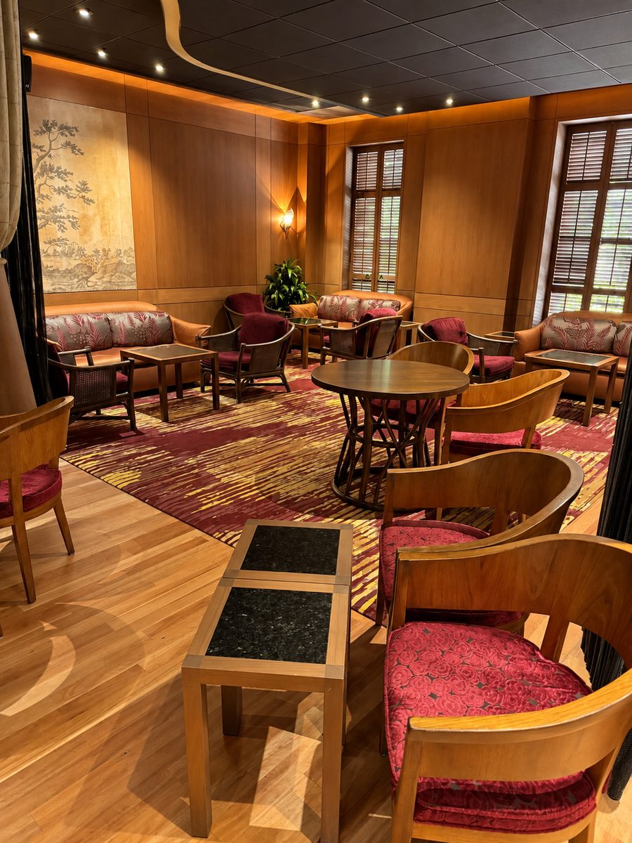 Halekulani, a wood-panelled lounge with armchairs and low tables