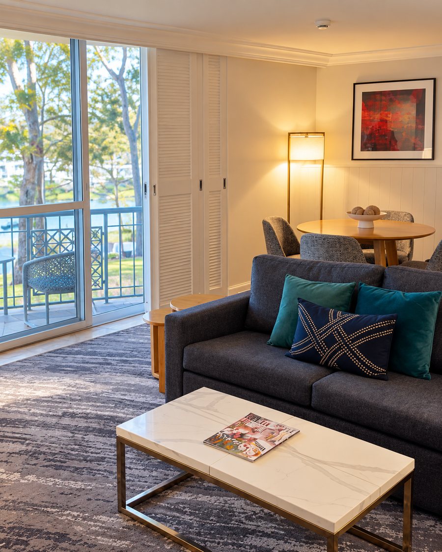 InterContinental Sanctuary Cove Resort, suite lounge with a sofa, a round dining table and a balcony over the water