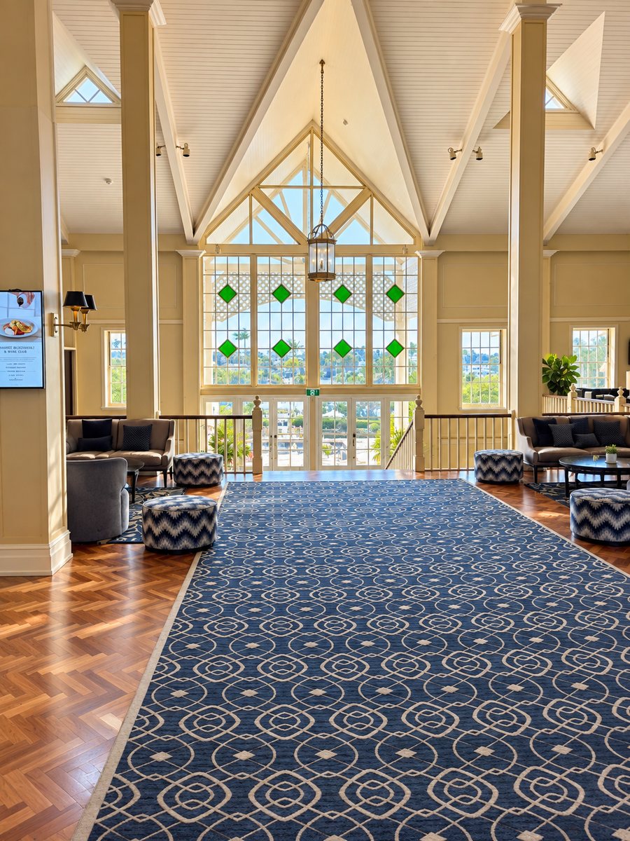 InterContinental Sanctuary Cove Resort, double height hall with a patterned runner and leadlight windows looking out to the marina
