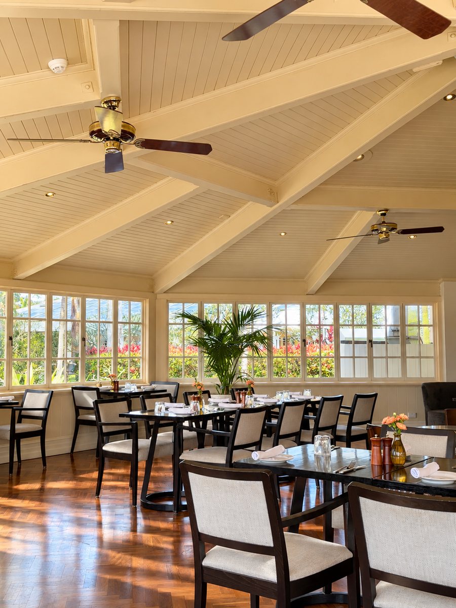 InterContinental Sanctuary Cove Resort, restaurant under a raked white ceiling with fans, tables set for service