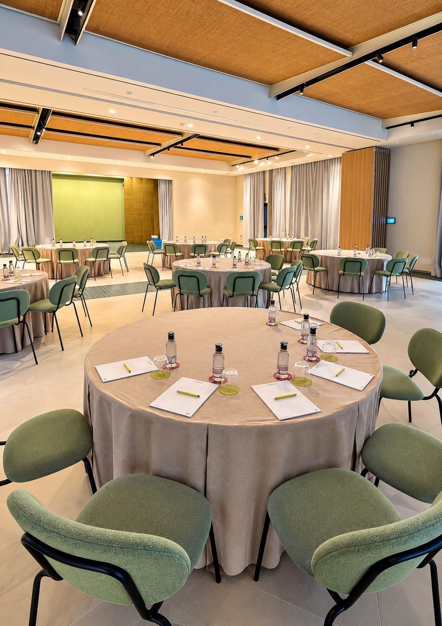 Kimpton Los Monteros Marbella, function room set with round tables, green chairs and a woven timber ceiling