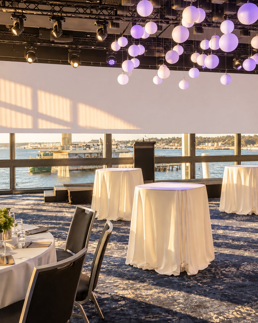 Pier One Sydney Harbour, Autograph Collection, function room set for a cocktail reception, with a lectern, stage and floor to ceiling harbour windows
