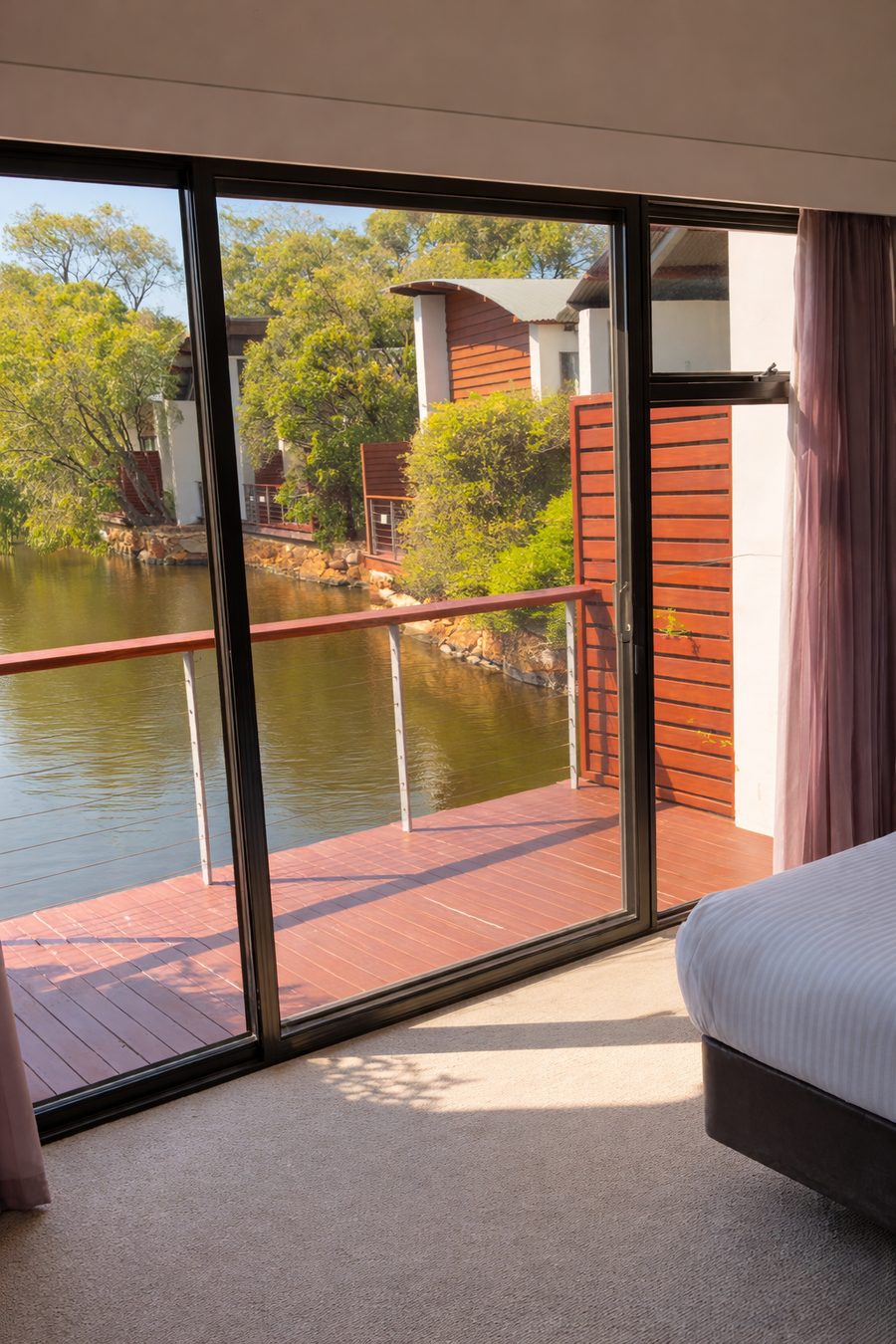 Pullman Bunker Bay Resort, villa bedroom opening onto a deck