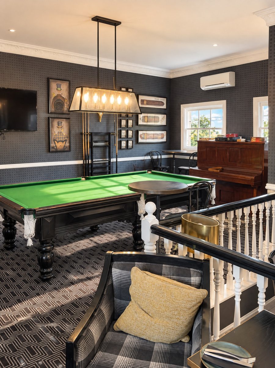 voco Kirkton Park Hunter Valley, games room with a full size billiard table under a lantern pendant, an upright piano and a window onto the garden